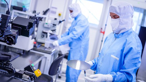 Workers in protective suits in the clean room