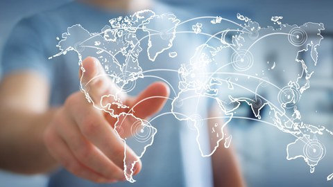 Image of a person pointing to a sketch map of the continents. Various destinations are connected by lines on the map.