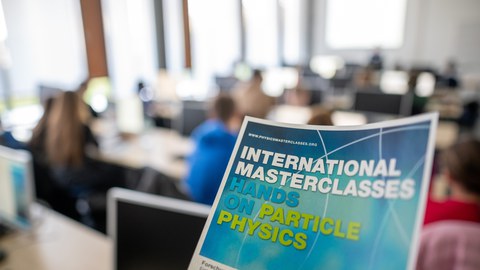 information flyer of the masterclasses with lecture room in the background