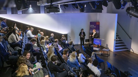 a full auditorium during a lecture at King's College London